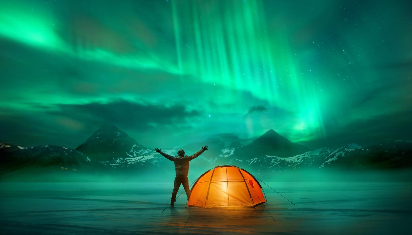 The wild camping survival guide - shu-Aurora-Borealis-Man-Camping-Triumphant-HERO-675590356-1440x823